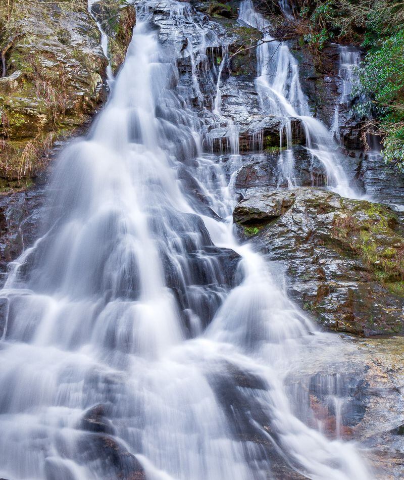 Small waterfall with water splashing and tumbling over the rocks